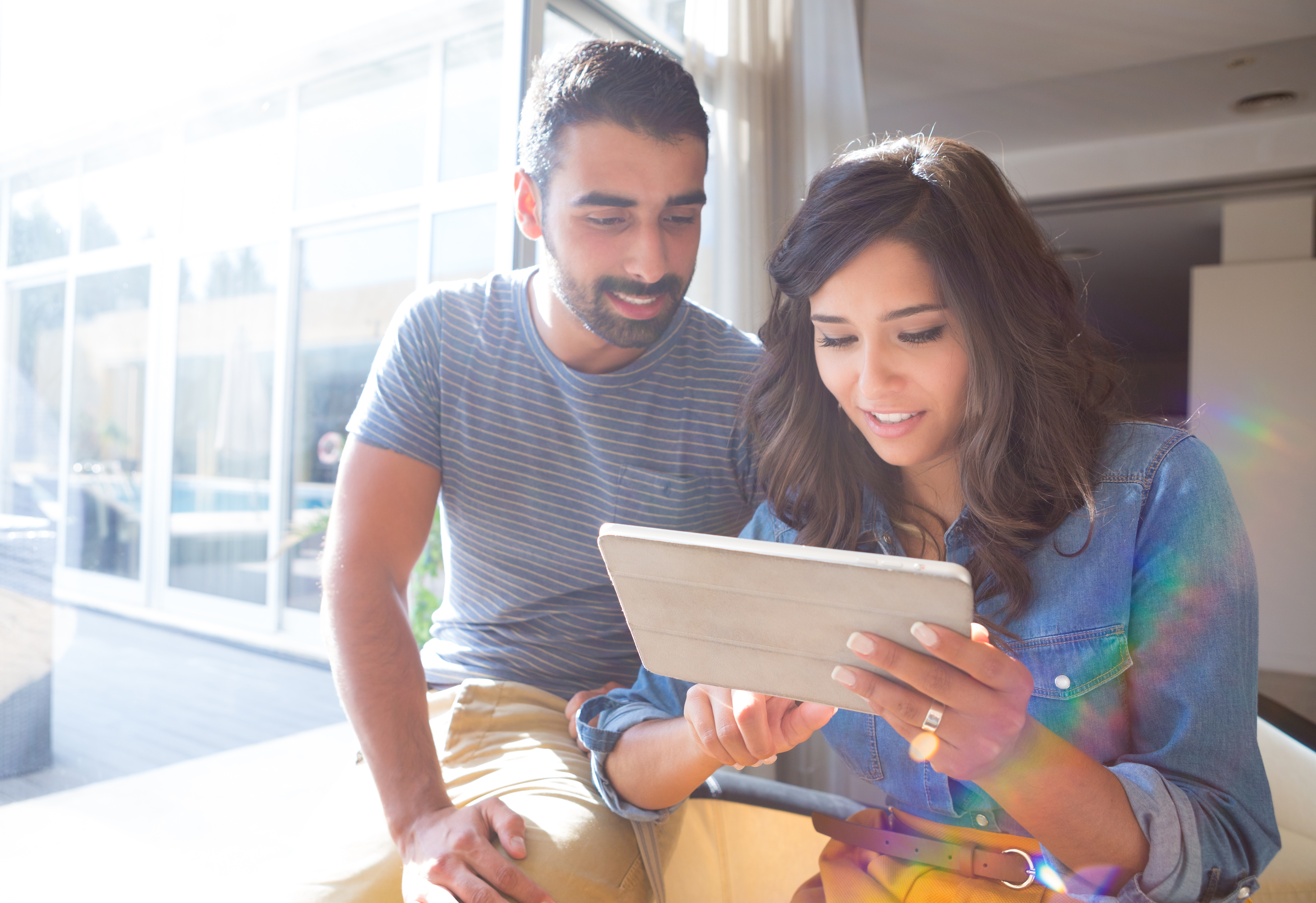 Two people looking at a tablet